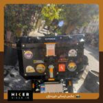 استیکر ضد آب با طرح ماشین جیپ و یک مرد جوان و نمای کوهستان در دوردست و نوشته Anywhere، مناسب باکس موتور