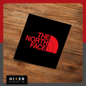 استیکر لوگوی "THE NORTH FACE"، با زمینه مشکی و نوشته قرمز، مناسب برای تمام سطوح،