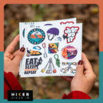 شیت استیکر با تم صخره‌نوردی حاوی تصاویر: دختر صخره‌نورد در حال صعود، هارنس سنگ‌نوردی، طناب گره‌خورده، ابزار حمایت، و استیکر تایپوگرافی Just Do It با فونت گرافیتی و رنگ نارنجی.